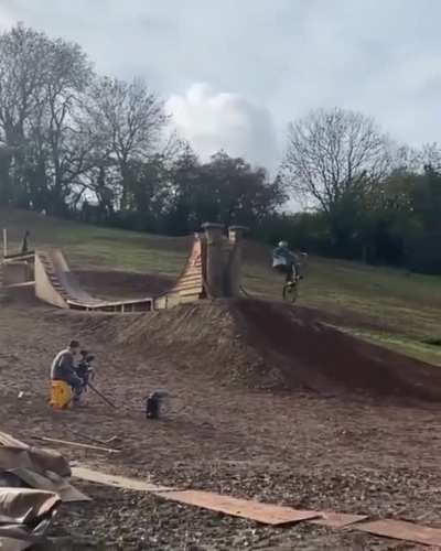 Professional Mountain Bike Rider Matt Jones lands a back flip to front flip off a hitching post