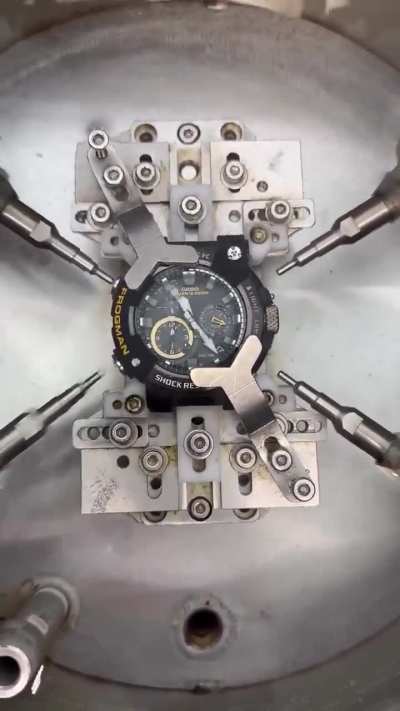 A G-Shock Frogman undergoing underwater button endurance testing to ensure sealing and reliability.
