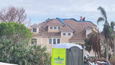  Not strapped in, top of three story house, walking on broken tiles.