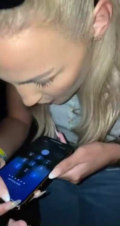 A girl using her spit to unlock her phone.