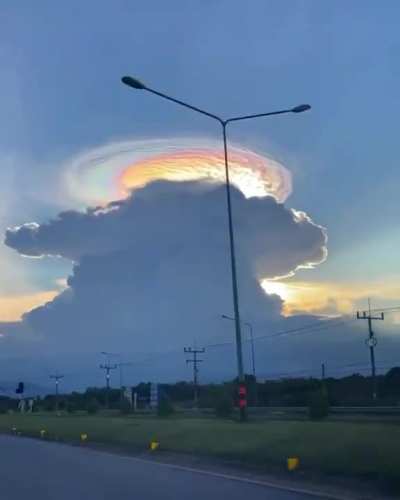 Cloud iridescence, an optical phenomenon caused by small ice crystals scattering the sun's rays, filmed in Narathiwat, Thailand.