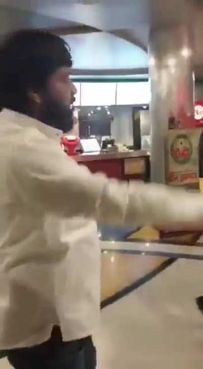 Hindu nationalists Jai Shree Raming and barging into a theatre to prevent people from watching Pathan