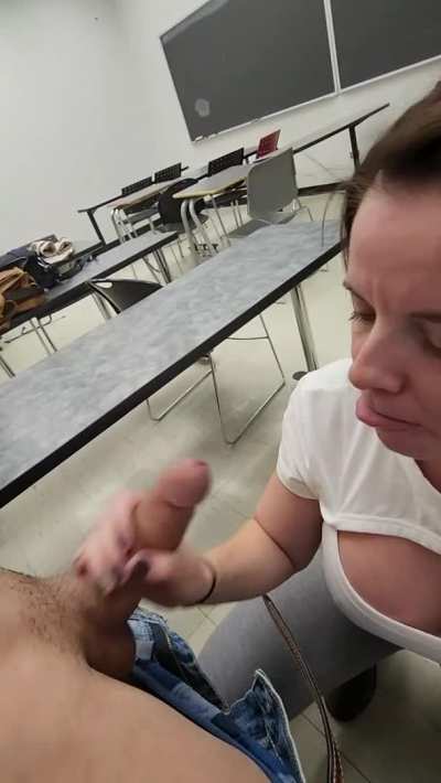 In a classroom sucking cock while students were walking around outside