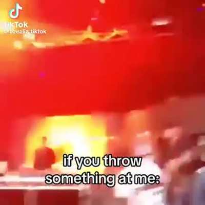 Azealia Banks demonstrating how to respond if a fan throws something at a performer.