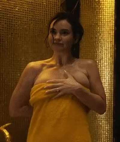 “Oh hey baby! What are you… I was in the shower why would you come in here?” Mommy Lily James asks as she covers her sexy body up