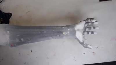Realistic humanoid robotic arm that uses artificial muscles has full range of motion and can lift a dumbbell
