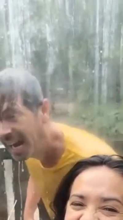 He take a shower.