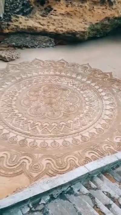 Finishing touches to an amazing piece of sand art