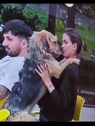 Woman kissing a dog