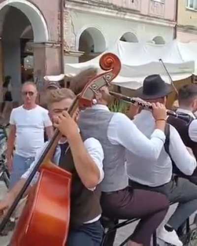 Music band in Poland playing on a bike riding through town