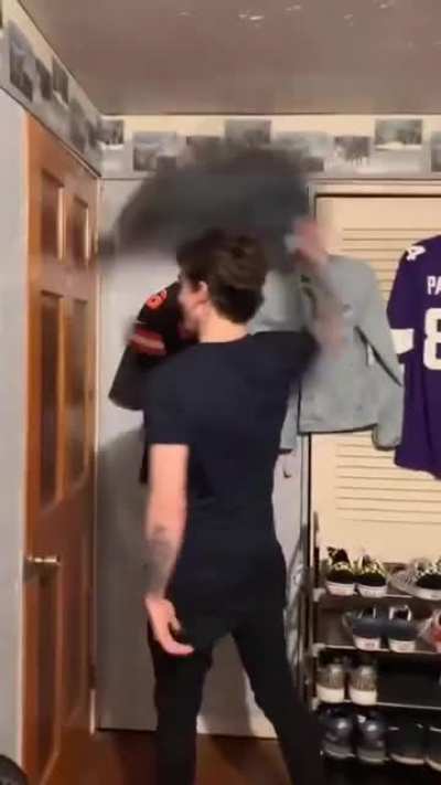 Attempting to break a thick wooden door... With his head