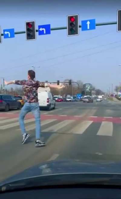 This man’s way of passing time at the red light