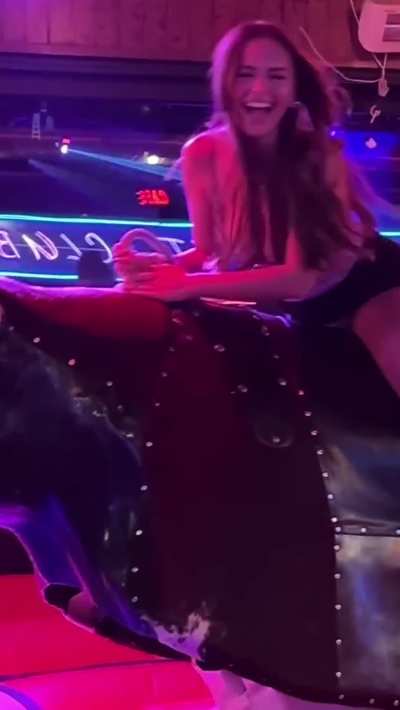 Sexy Bull Riding Babe in a Short Skirt