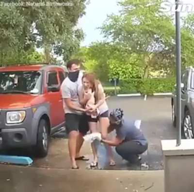 Just steps away from the clinic, but the baby doesn’t care.