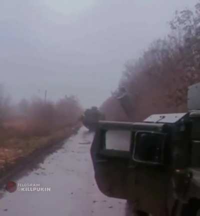 M270 launching missiles on a small Ukrainian road. Protected by a Humvee crew.