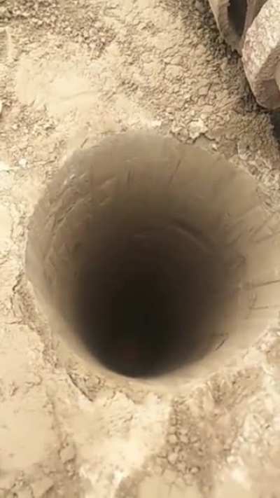 Construction worker going into a deep hole