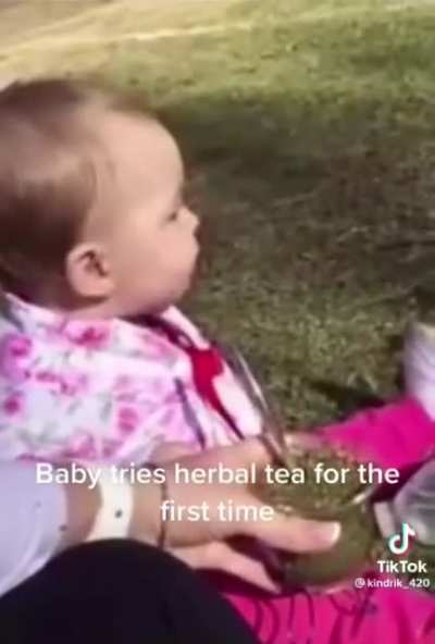 Baby tries herbal tea for the first time.