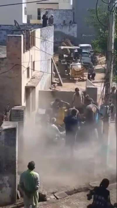 During Holi celebrations, a man standing on the rooftop of a house was seen throwing sand down towards people on the street. What happened next needs to be seen