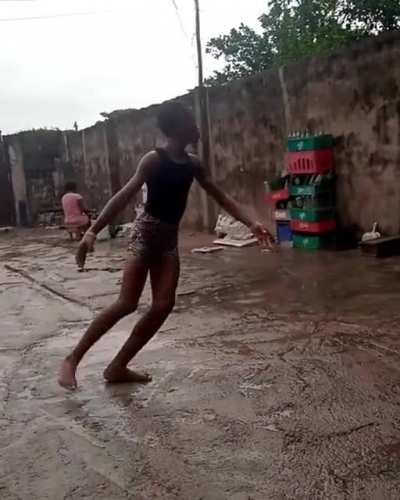 Anthony from Nigeria Dancing ballet barefooted on concrete while raining.