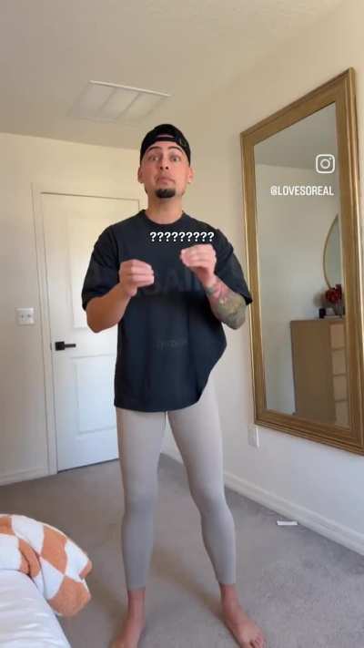Her husband showing what she looks like putting on her leggings. (0:22)