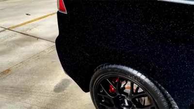 Mitsubishi Lancer Evolution painted with Musou Black and covered with colour shifting pearl particles.