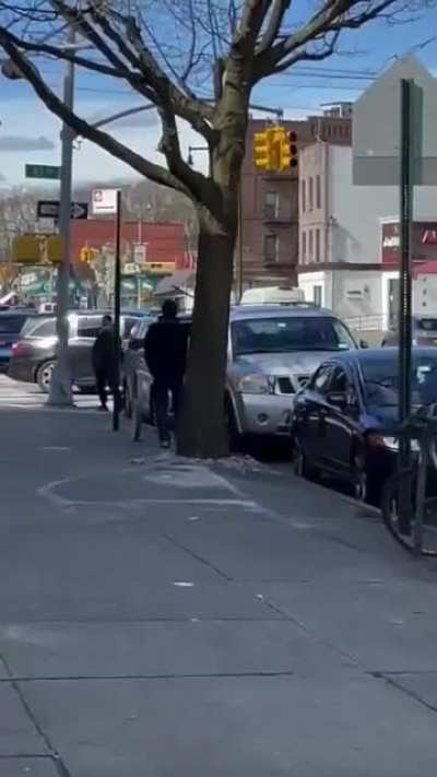 Man smashing car windows with a metal pipe in NYC.