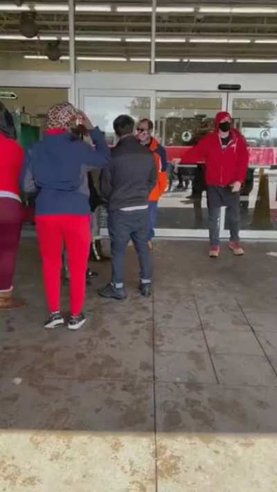A crowd of angry people attempt to enter a grocery store (HEB) in Texas.