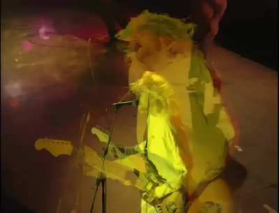 Mocking rumors of his drug use and health Kurt Cobain is brought on stage in a wheelchair and wig, plays entire show in a hospital gown, 1992