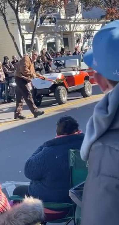 Crowd cheers for man cleaning up horse crap at Plymouth Thanksgiving Parade.