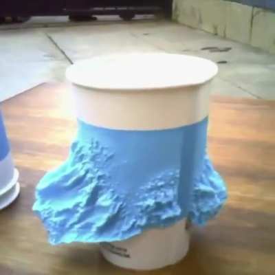 Cup grows own insulating collar when hot beverage is poured in to protect hands.