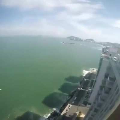 Casually getting a beer while paragliding