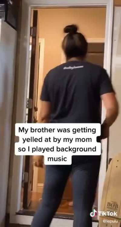His brother was getting yelled by thier mother so he thought that playing some background music would be a good idea