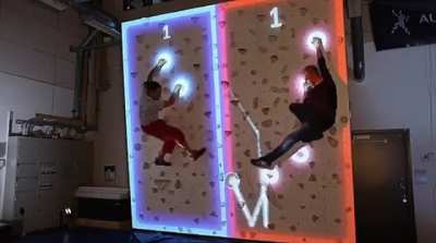 Climball is an augmented rock-climbing-wall game combining air hockey with rock climbing and it looks fucking awesome