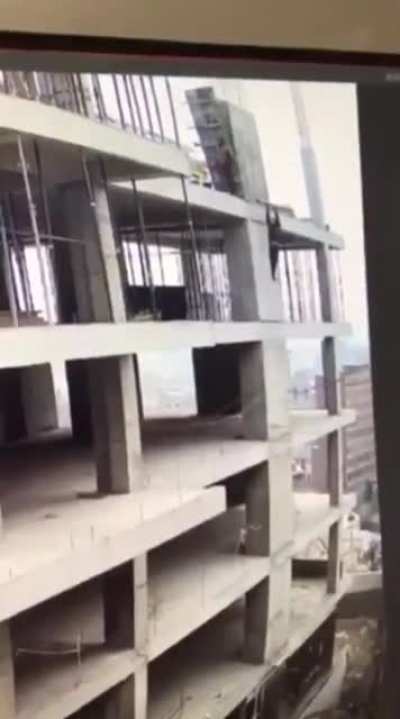 construction worker saves himself from falling down building