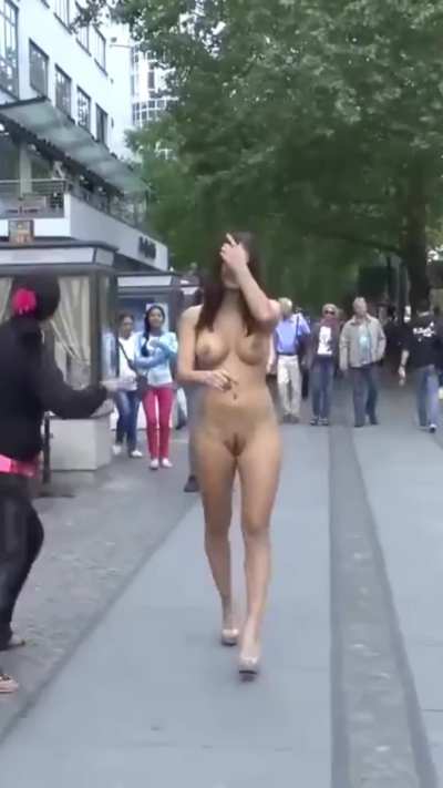 A sexy woman left only her high-heeled shoes on and went for a walk. Interesting reactions from strangers passing by.