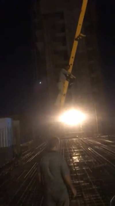 Pump operator lifts himself up to the top floor using the hose. About 4 stories high.