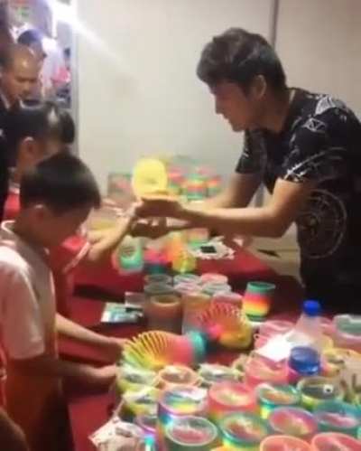 A vendor showing his amazing slinky skills. Yes, slinky skills