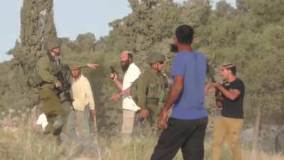 Armed Jewish settlers in the West Bank in the midst of the Israeli army who protect them, shoot at Palestinians.