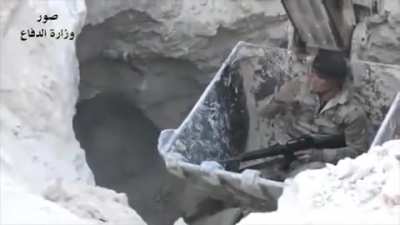Soldier lowered into a tunnel in a excavator to clear ISIS militants.