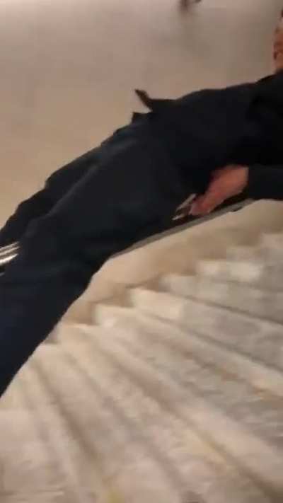 Sliding down public stairways