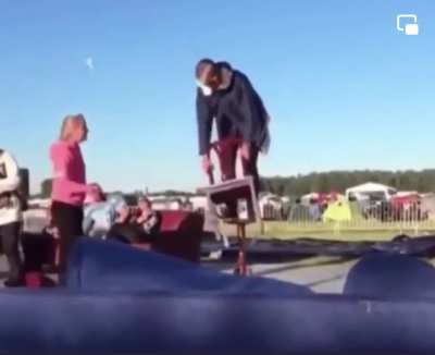 Standing on a table and hitting the table with a chair