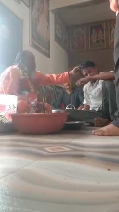 Spiritual healer cleansing bad spirits from a helpless guy