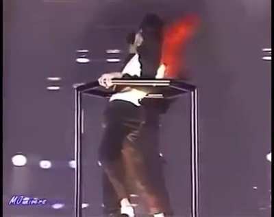 Man jumps on a crane with Michael Jackson during a show