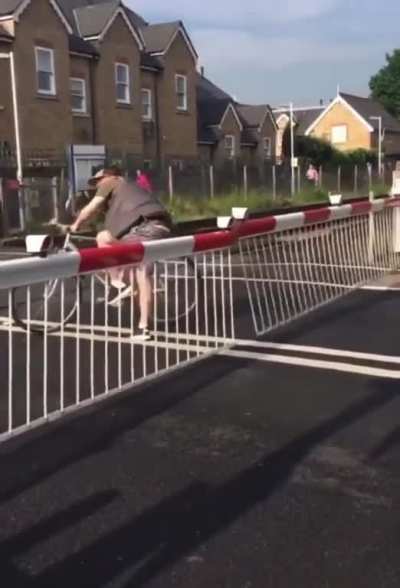 Man has no time for closed railroad crossing gate