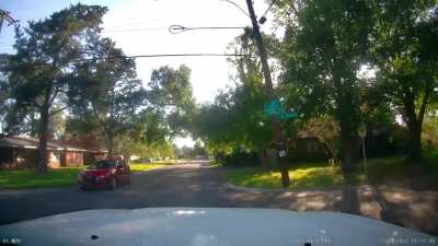 Idiot blows through stop sign at full speed.