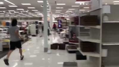 Dozens of people loot the Target store near Minneapolis Police's 3rd Precinct building in the midst of the George Floyd protest.
