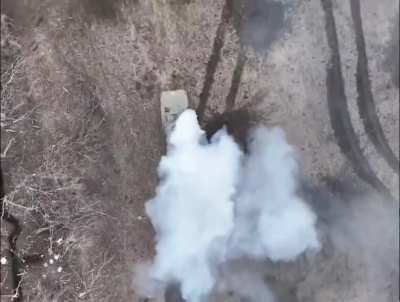 Russian BMP-1 is being hit by drone dropped munition while troops are falling out of the back.
