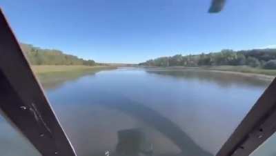 Ukrainian helicopter at a low altitude above the water surface.