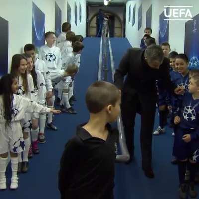 Jose Mourinho giving high fives to kids