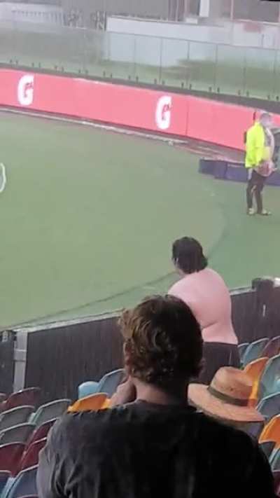 Dude enjoys the rain at the Gabba